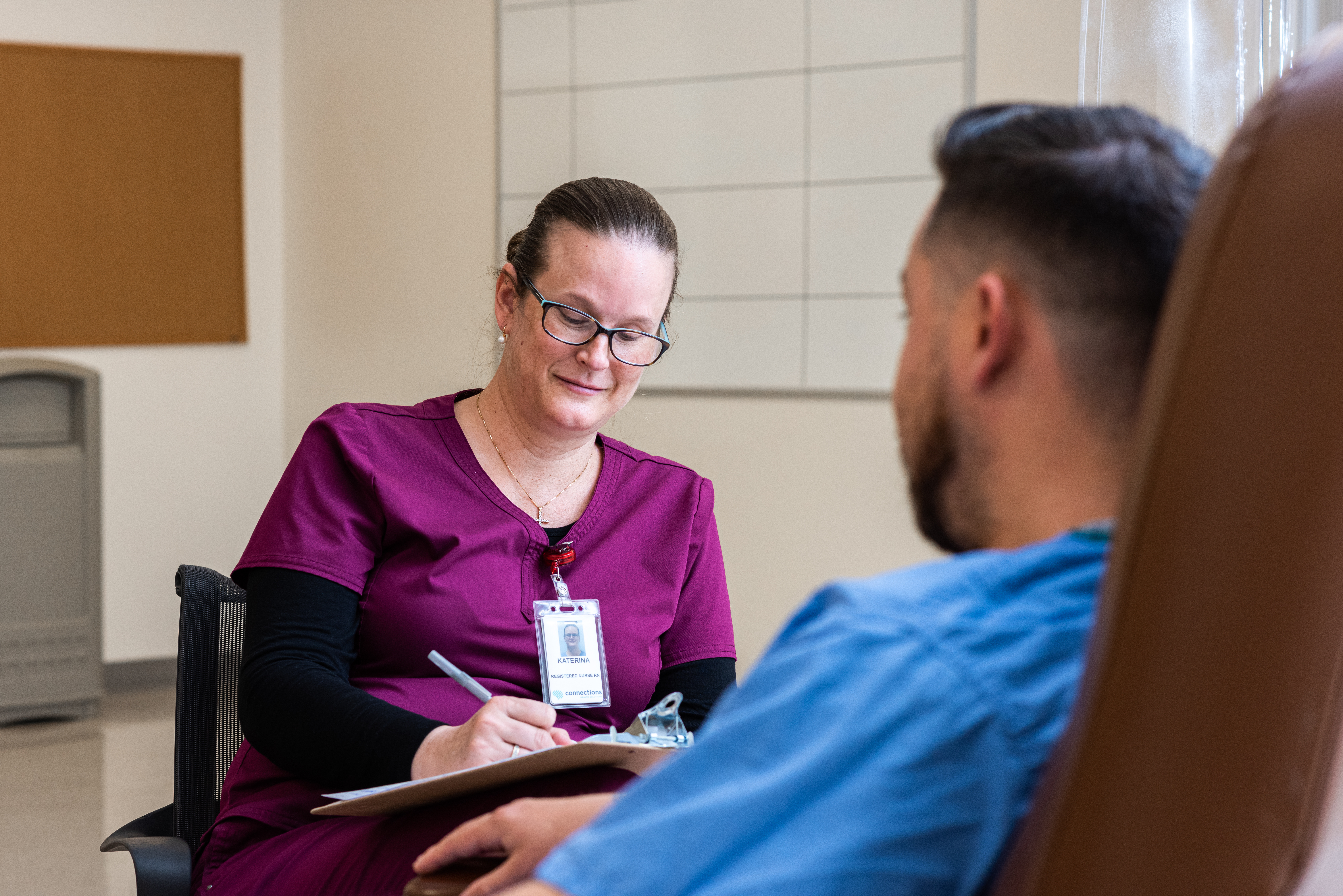 A nurse meeting with an individual at a behavioral health center